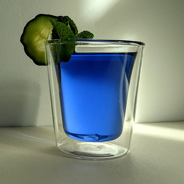 Glass showing a blue butterfly pea infusion